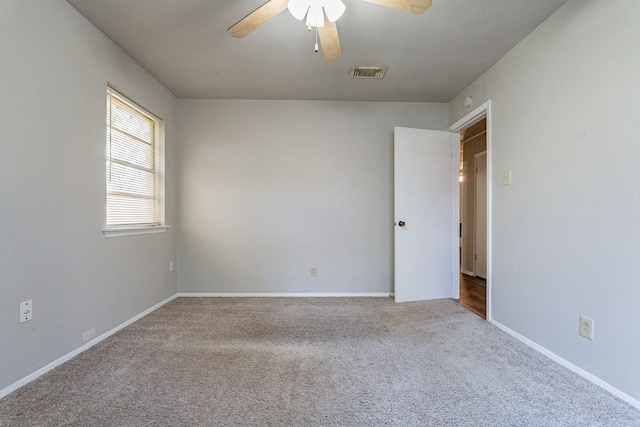 empty room with light colored carpet and ceiling fan