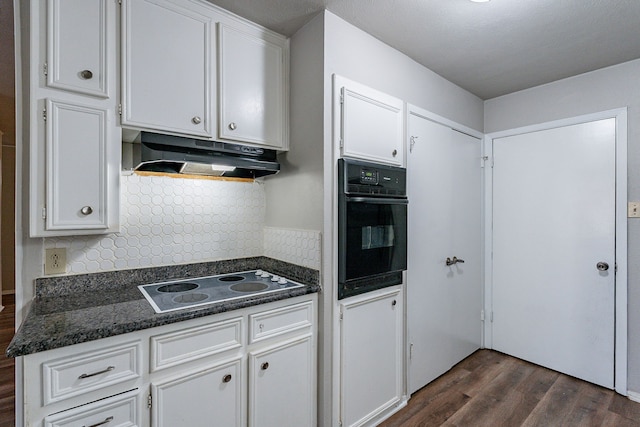 kitchen with white cabinets and oven