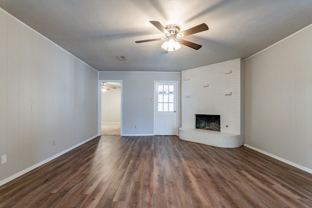 unfurnished living room featuring a fireplace, ceiling fan, and dark wood-type flooring