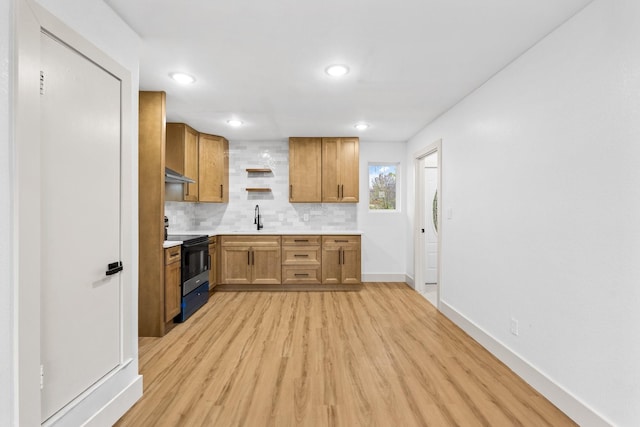 kitchen with sink, tasteful backsplash, black electric range, light hardwood / wood-style flooring, and exhaust hood