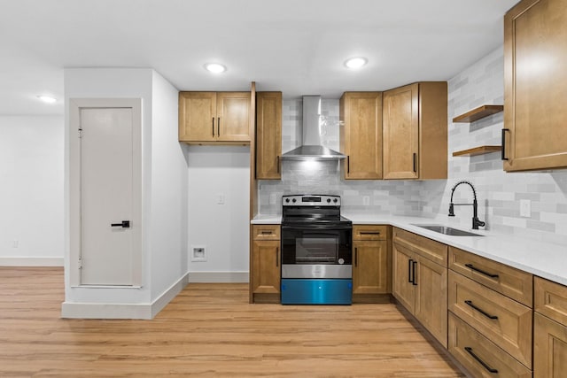 kitchen with range with electric stovetop, sink, decorative backsplash, light hardwood / wood-style floors, and wall chimney range hood