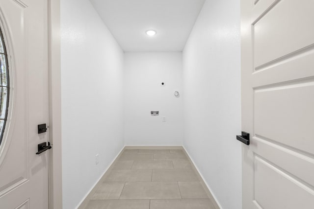 laundry room with hookup for an electric dryer and light tile patterned floors