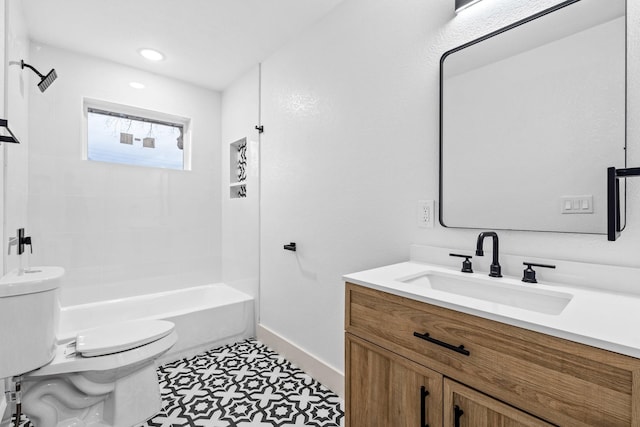 full bathroom with vanity, tiled shower / bath combo, and toilet