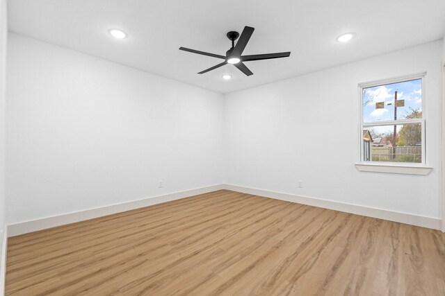 empty room featuring ceiling fan and light hardwood / wood-style flooring