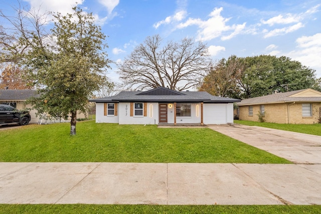 view of front of house with a garage and a front lawn