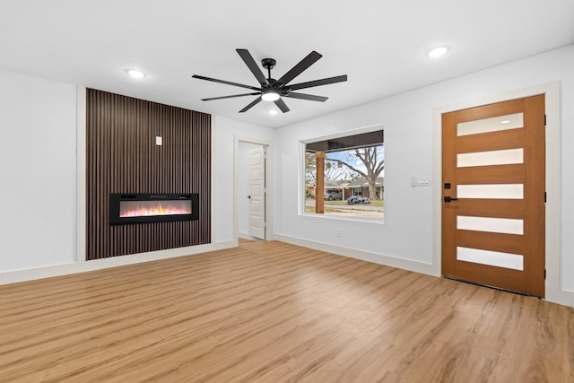 interior space with ceiling fan and light hardwood / wood-style flooring