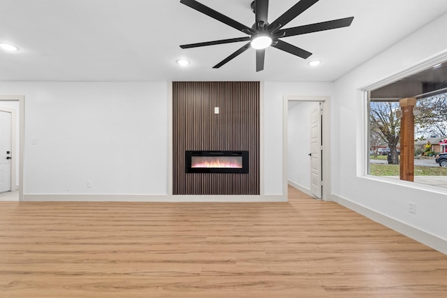 unfurnished living room featuring light hardwood / wood-style floors and ceiling fan