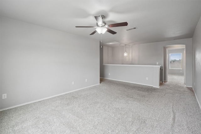 carpeted spare room with ceiling fan