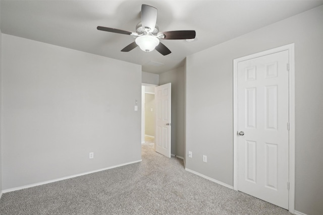 unfurnished bedroom with ceiling fan and light carpet