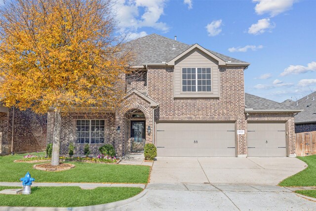 view of front of home featuring a garage and a front lawn