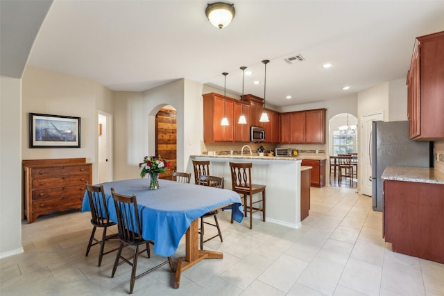 dining area featuring sink and a chandelier