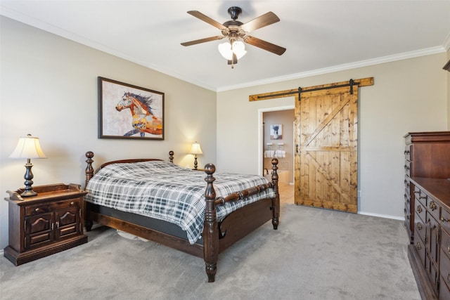 bedroom featuring crown molding, ceiling fan, connected bathroom, light colored carpet, and a barn door