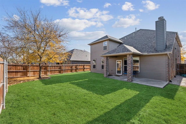 back of house featuring a lawn and a patio