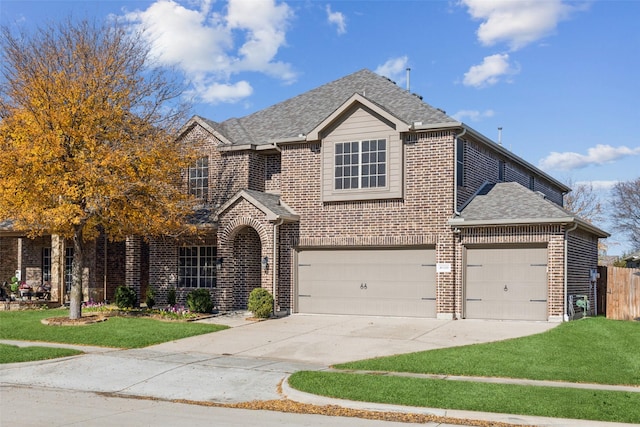 view of front of property featuring a garage and a front yard