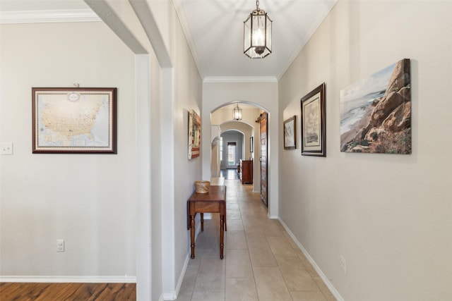 hallway featuring light tile patterned floors and ornamental molding