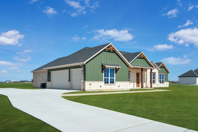 craftsman-style house featuring a garage, stone siding, cooling unit, board and batten siding, and a front yard