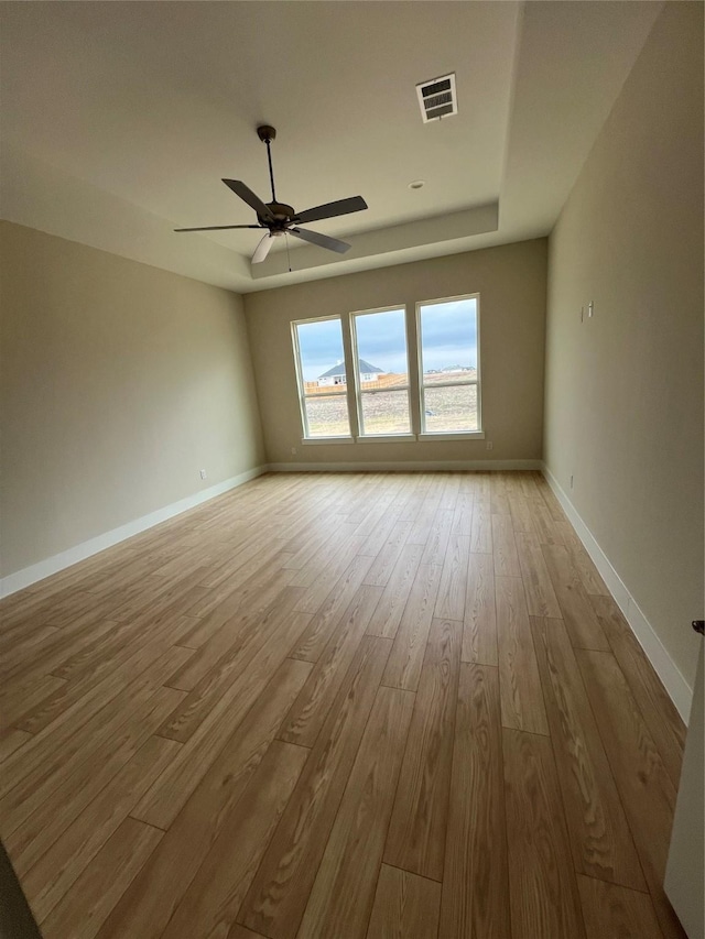 spare room featuring ceiling fan and light hardwood / wood-style flooring