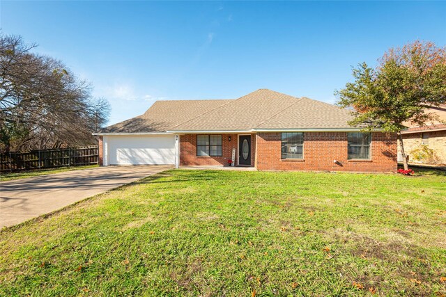 ranch-style house with a garage and a front yard