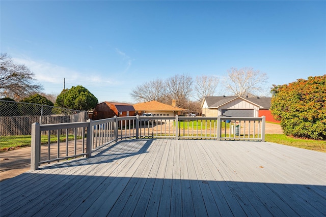 wooden terrace with a garage and an outbuilding