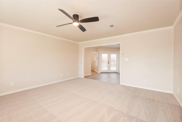 empty room with carpet, french doors, ornamental molding, a textured ceiling, and ceiling fan