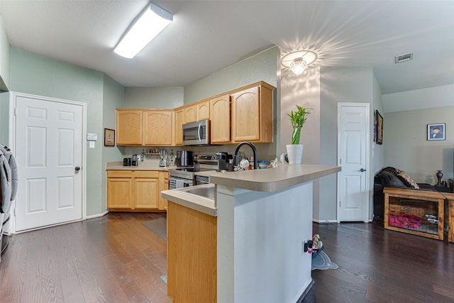 kitchen featuring dark hardwood / wood-style flooring, light brown cabinets, kitchen peninsula, and appliances with stainless steel finishes