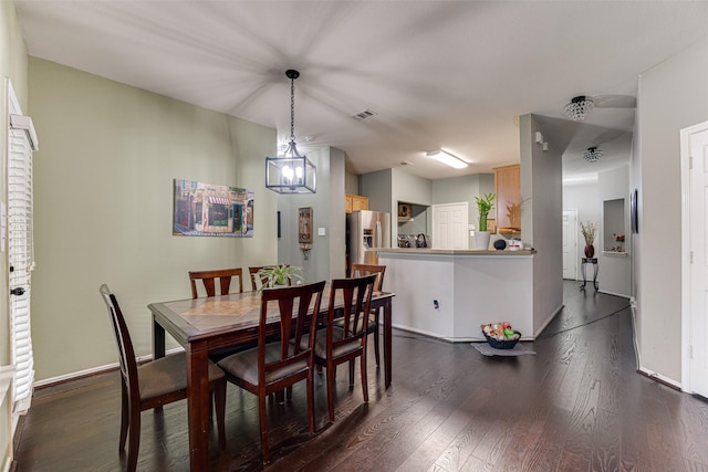 dining room with dark hardwood / wood-style flooring