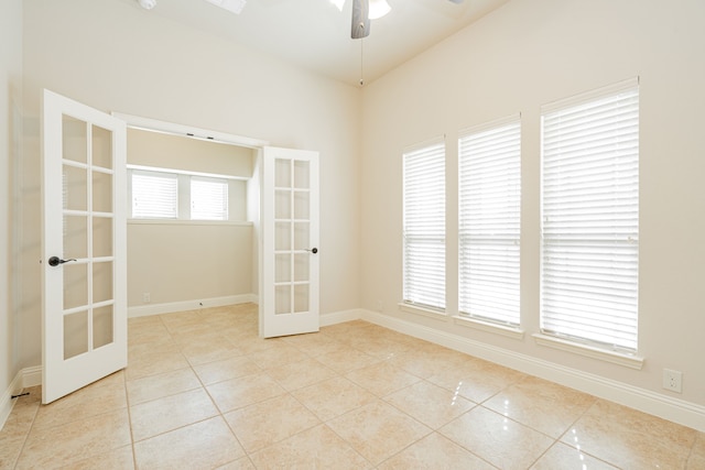 unfurnished room featuring ceiling fan, french doors, and light tile patterned floors