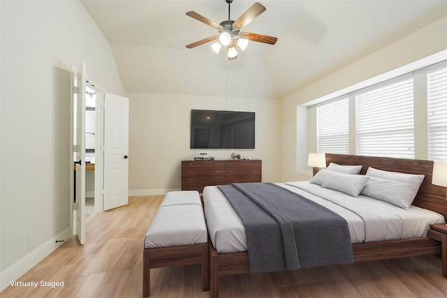 bedroom with ceiling fan, light hardwood / wood-style floors, and vaulted ceiling