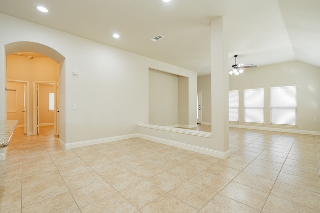 tiled empty room featuring ceiling fan and lofted ceiling