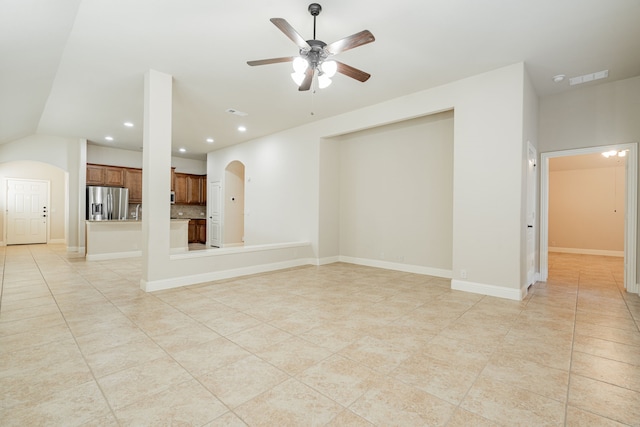 unfurnished living room featuring ceiling fan, light tile patterned floors, and vaulted ceiling