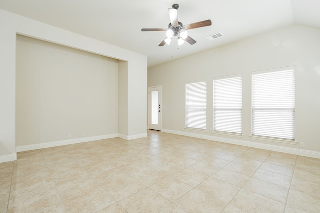 tiled empty room with vaulted ceiling and ceiling fan