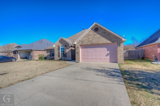 view of front facade featuring a front yard and a garage