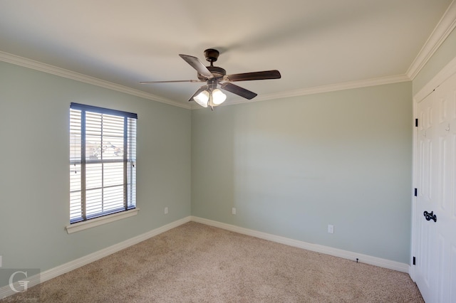 spare room featuring light colored carpet, ceiling fan, and crown molding