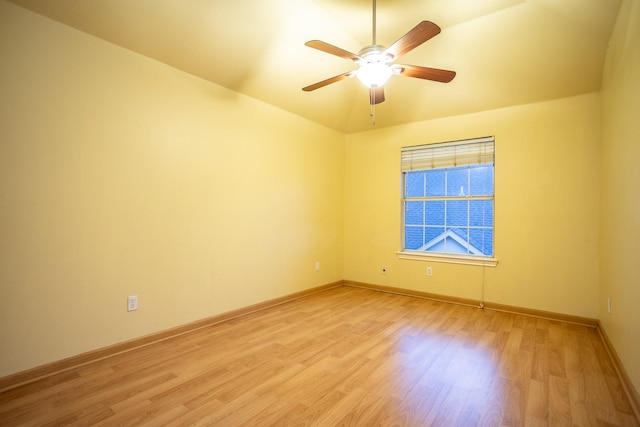 unfurnished room with ceiling fan, lofted ceiling, and light wood-type flooring