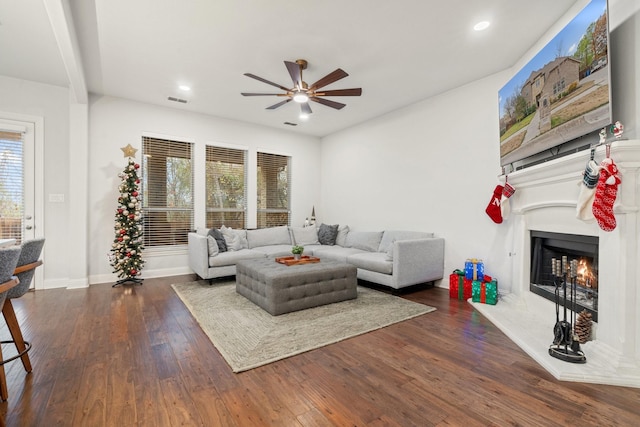 living room with dark hardwood / wood-style flooring and ceiling fan