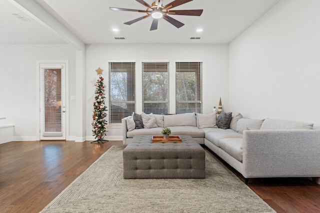 living room featuring ceiling fan and dark hardwood / wood-style flooring