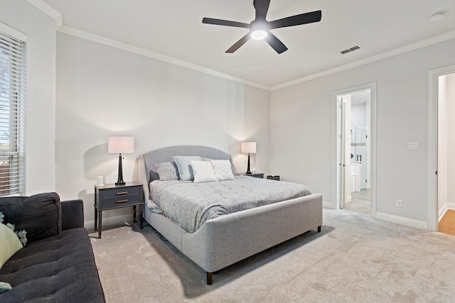 bedroom with crown molding, light colored carpet, ensuite bathroom, and ceiling fan