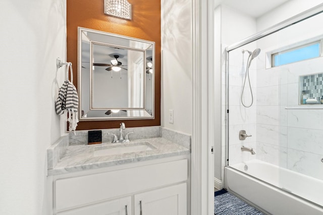 bathroom featuring tiled shower / bath combo and vanity