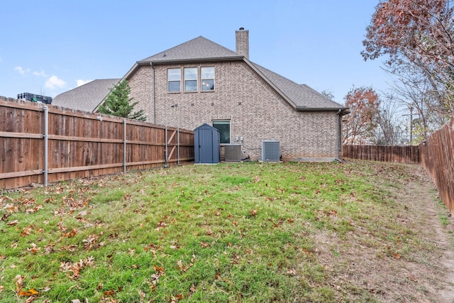 back of property featuring a yard and cooling unit