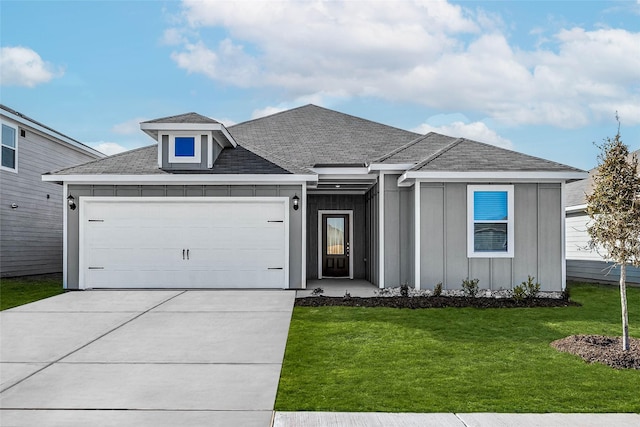 view of front of home featuring a garage and a front lawn