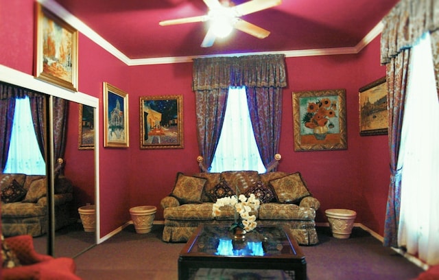 carpeted living room with ornamental molding and ceiling fan