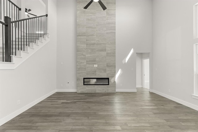 6104 Mulberry Ln, Celina, TX 75009 - unfurnished living room featuring a towering ceiling, wood finished floors, and a ceiling fan