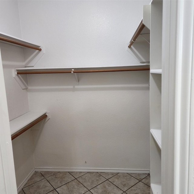 walk in closet featuring light tile patterned flooring