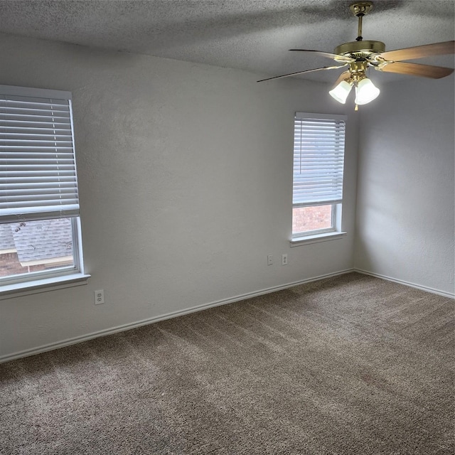 carpeted empty room with ceiling fan and a textured ceiling