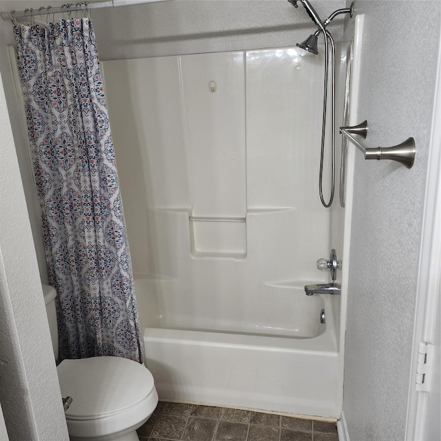 bathroom with shower / bath combination with curtain and toilet