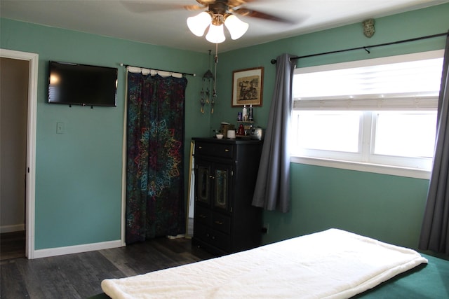 bedroom with ceiling fan and dark hardwood / wood-style flooring