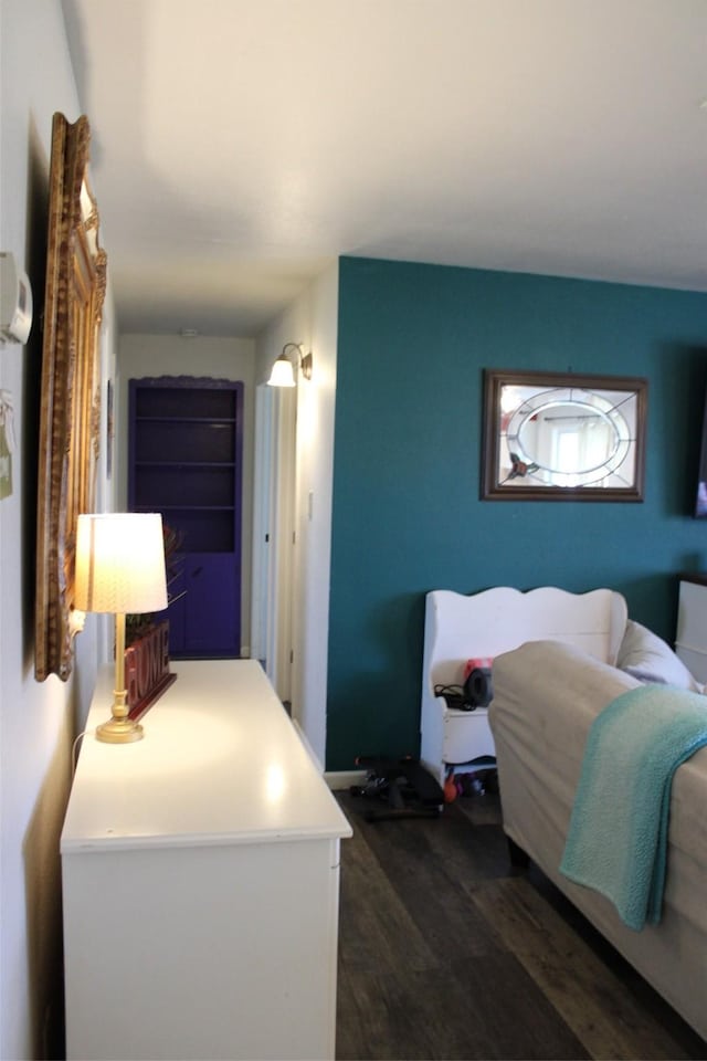 bedroom with dark wood-type flooring