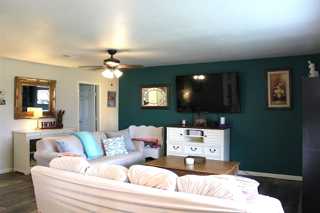 living room with dark hardwood / wood-style flooring and ceiling fan