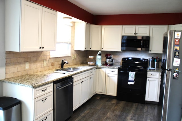 kitchen featuring light stone countertops, white cabinetry, appliances with stainless steel finishes, and sink