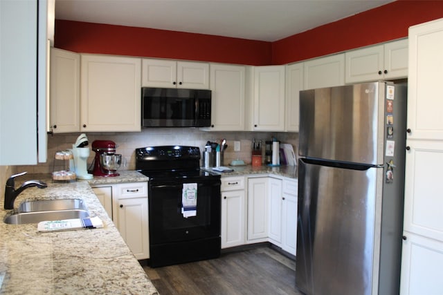 kitchen with sink, white cabinetry, black electric range, stainless steel refrigerator, and decorative backsplash